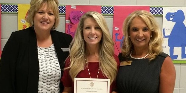 Taylor, center, is pictured with her letter from Deal.