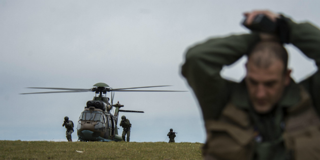 PLOVDIV, Bulgaria - Members of the Bulgarian Special Forces exit a Bulgarian AS-532 Cougar helicopter and move toward Italian air force Captain Roberto Manzo, a 74th Expeditionary Fighter Squadron A-10C Thunderbolt II aircraft exchange pilot, during combat search and rescue training near Plovdiv, Bulgaria, Feb. 11, 2016. The Special Forces had to verify that Manzo is the correct person they are looking for before extracting him. (U.S. Air Force photo by Airman 1st Class Luke Kitterman/Released)
