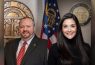 Two smiling officials with Georgia state seals