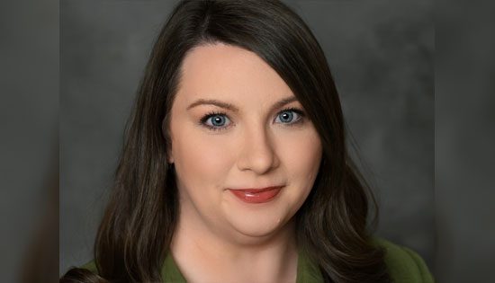 Woman with long hair and green shirt.