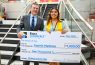 Two people holding oversized $1,000 scholarship check