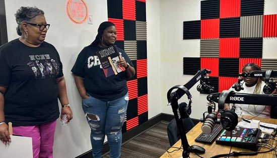 Three people podcasting in a small studio