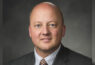 Man in suit with striped tie portrait.