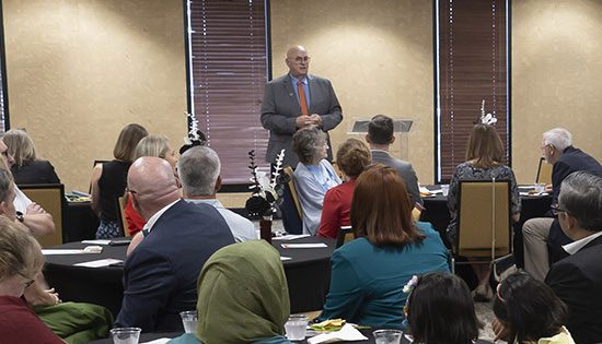 Speaker addressing audience at conference event.