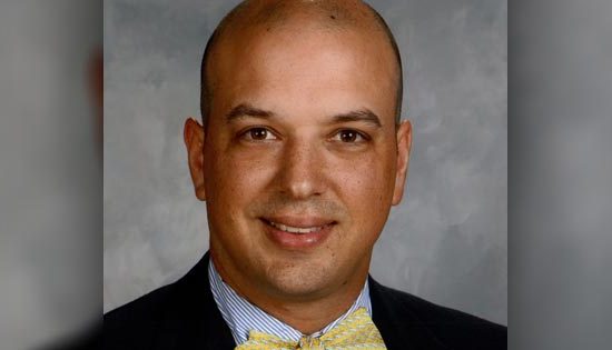 Man in yellow bow tie, formal attire.