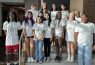 Group of smiling teenagers in matching t-shirts