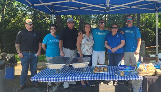 Group under canopy at outdoor event.